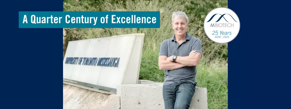 A Quarter Century of Excellence: MBiotech 25 Years (2000-2025) | Scott Prosser stands at the main entrance of UTM